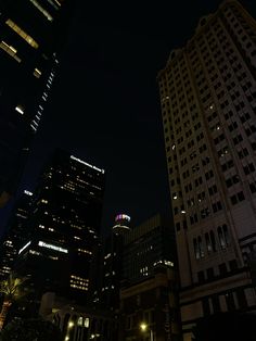 some very tall buildings at night time