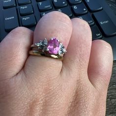 a person's hand with a ring on it and a keyboard in the background