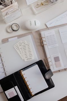 an office desk with binders, papers and other items on it's surface