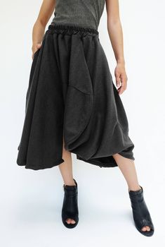 "🚚..ALL ORDERS ARE SHIPPED VIA DHL EXPRESS MAIL Treating every design as a piece of art, look no further than asymmetric midi skirt/pants. This special design skirt has one leg of pants. Asymmetric panelled construction. Wide elastic waistband. Tonal stitching. Asymmetric hem. * Pull-on style * 2\" elastic waistband * The skirt has one left leg of pants * Tonal stitching * Side seam pockets * Asymmetric hem * Unlined Measurements approximately: Waist: 26\" stretching to 46\" (66 cm-117 cm)-elas Asymmetrical Fitted Lined Skirt, Fitted Asymmetrical Lined Skirt, Asymmetrical Cotton Bottoms For Fall, Black Relaxed Skirt With Asymmetrical Hem, Avant-garde Fitted Asymmetrical Skirt, Asymmetrical Baggy Bottoms For Spring, Baggy Asymmetrical Bottoms For Spring, Baggy Pleated Skirt For Fall, Spring Baggy Asymmetrical Bottoms