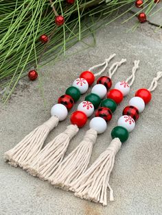 four tasselled christmas ornaments sitting on the ground