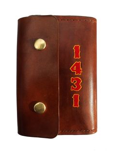 a brown leather case with the number four in red and yellow on it's side