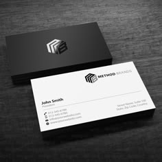 a black and white business card sitting on top of a table