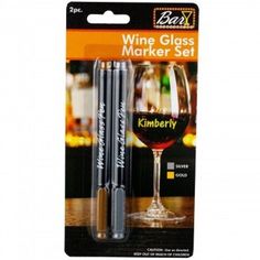 wine glass marker set with two markers in front of the package and an empty bottle next to it