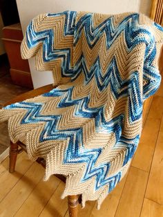 a crocheted chair with a blue and white blanket on it's back