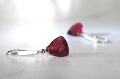 "Gorgeous red trillion of AAA quartz with a sparkle of warm gold for simply stunning earrings. Drops of pure, gorgeous red with just an ever so slight tinge of pink! So pretty and delicate and so luscious! Red ruby quartz in a trillion cut accented with a tiny gold hematite, so perfect for that simple touch of elegance. A sterling silver ear wire has been slightly hammered and finished into a modern, sleek contemporary earwire. These are perfect pops of gorgeous color! Quartz Trillions are 12mm Ruby Quartz, Silver Gold Earrings, Red Quartz, Color Quartz, Earrings Red, Red Earrings, Red Ruby, Quartz Earrings, Stunning Earrings