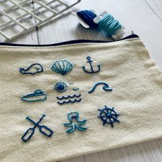 an embroidered pouch sitting on top of a white table