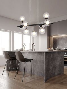 a modern kitchen with marble counter tops and pendant lights hanging from the ceiling over the island