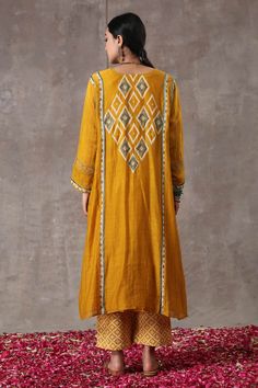 Yellow long kurta with geometric hand block prints and embroidered highlights. Paired with printed pant.
Component: 2
Pattern: Printed
Type Of Work: Hand Block Print
Neckline: Round
Sleeve Type: Full
Fabric: Chanderi, Cotton Flax
Color: Yellow
Other Details: 
Front button placket
Occasion: Mehendi and Haldi - Aza Fashions Long Kurta, Hand Block Print, Agra, Pant Set, Set For Women, Aza Fashion, Button Placket, Sleeve Type, Block Print