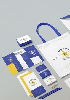 an assortment of stationery items including a tote bag, business cards and envelopes