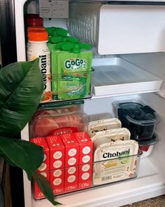 an open refrigerator filled with lots of different types of drinks and food items in it