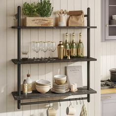 the shelves in the kitchen are filled with dishes and wine glasses