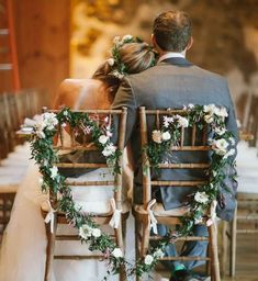 the bride and groom are sitting on their chairs