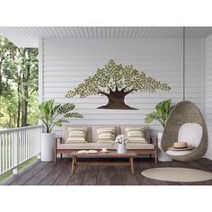 a porch with a swing chair, table and potted plants on the back deck