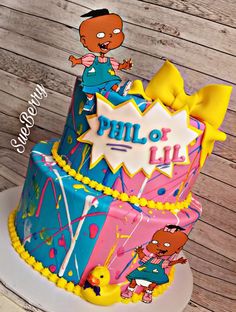 a birthday cake decorated with cartoon characters and the words philo lil on it's side