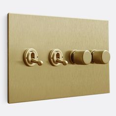 an electrical outlet with three knobs and two switches on each side, in gold