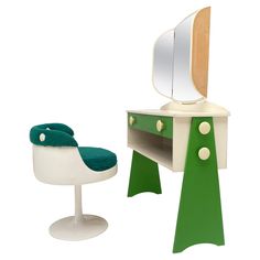 a green and white dressing table next to a chair with a mirror on the top