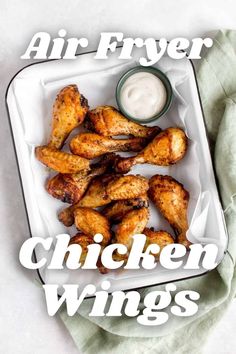 air fryer chicken wings with ranch dip in the middle on a white platter