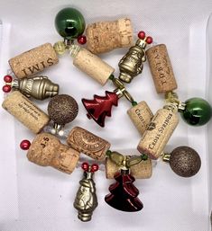 a bunch of wine corks that are laying on a white table cloth with red and green beads