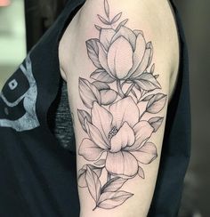 a black and white flower tattoo on the arm