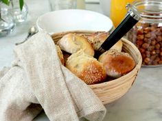 a basket filled with pastries sitting on top of a counter next to other foods