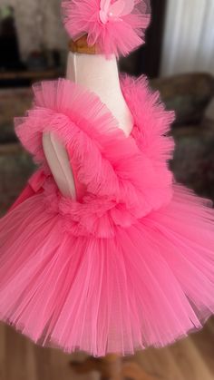 a dress made out of tulle on a mannequin headdress with pink ruffles