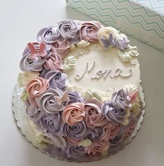 there is a cake decorated with flowers and the name flora on it's side