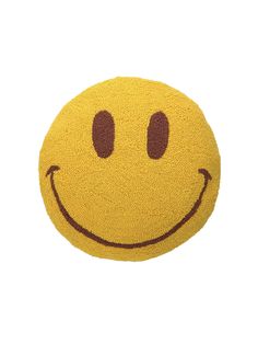 a yellow smiley face pillow with two eyes