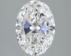 an oval cut diamond on a gray background