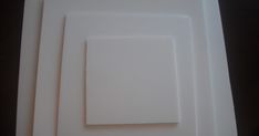 three square white plates sitting on top of each other