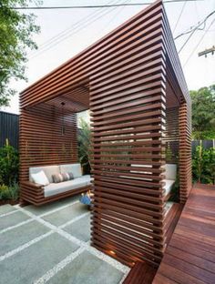 an outdoor living area with wooden slatted walls