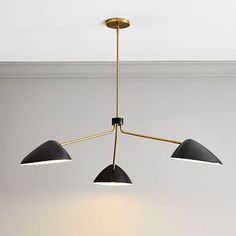 three lights hanging from a ceiling fixture in a room with white walls and flooring