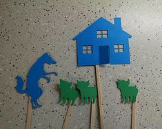 some toothpicks with houses and horses on them