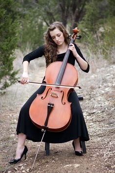 a woman in black dress playing an instrument