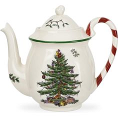 a tea pot with a christmas tree painted on it