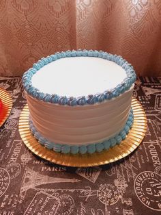 a white and blue cake sitting on top of a table