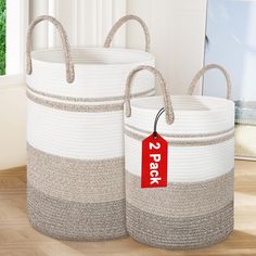 two large baskets with tags on them sitting on the floor