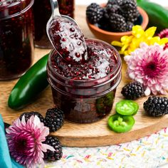 blackberry jam in a jar with fresh blackberries and raspberries on the side