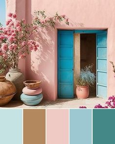 a pink house with blue doors and flowers