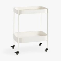 a white shelf with wheels on it