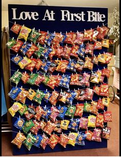 a large display of love at first bite candies in front of a sign that says love at first bite