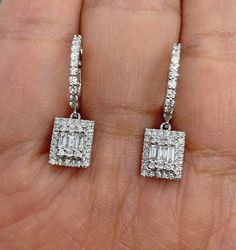 Beautiful Diamond Drop Earrings set with white and sparkling diamonds. Just dangle below the lob, not too long. Classy and pretty earring. The hoop earring fits nice around the lobe. These earrings you can easily dress up or down in them. Excellent craftsmanship, all diamonds are set nice and smooth. The cluster of emerald cut diamond is classy and beautiful. The length measures about 24.2 x 7.3mm. The dangle measures about 8.8 x 7.3mm. The hoops snaps tightly for a secure fit. Genuine natural b White Gold Baguette Diamond Dangle Jewelry, White Gold Dangle Jewelry With Baguette Diamonds, Luxury Single Cut Diamond Dangle Earrings, Anniversary Jewelry With Baguette Diamonds And Dangle Design, Anniversary Jewelry With Baguette Diamonds Dangle, Dangle Jewelry With Baguette Diamonds For Anniversary, White Gold Diamond Cluster Dangle Earrings, Anniversary Jewelry With Baguette Diamonds And Dangle Shape, Anniversary Dangle Jewelry With Baguette Diamonds