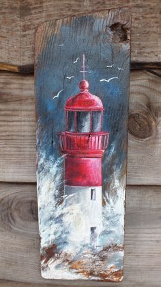 a painting of a red lighthouse on wood