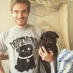 a man holding a small black dog in his arms with the caption teen choice awards 2013