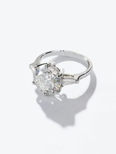 Classy and timeless, this 3-carat round natural diamond 3-stone ring in 18K white gold offers a radiant, fairytale-inspired look. Best Brilliance Engagement Rings.