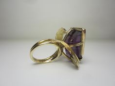 "This completely unique and one of a kind ring was purchased from the estate of a jewelry designer who made many custom and unique pieces in our local area around Cleveland, Ohio in the 70's and 80's. The 14k gold setting features a split ring shank and gold leaves that circle around and beneath the gigantic gemstone. The gemstone is a violet-blue to purple color-change sapphire in a free form cut. Gemstone Dimensions - 27mm x 18mm x 9.5mm Ring Size 5.5. (Can easily be resized to most sizes) Mar Unique Formal Rings With Polished Finish, Unique Yellow Gold Collectible Jewelry, Modern 14k Gold Collectible Jewelry, Unique 14k Gold Rings With Polished Finish, Modern Yellow Gold Collectible Rings, Collectible Modern 14k Gold Jewelry, Modernist Hallmarked 14k Gold Jewelry, Vintage Amethyst Rings With Polished Finish, Unique 14k Gold Hallmarked Rings