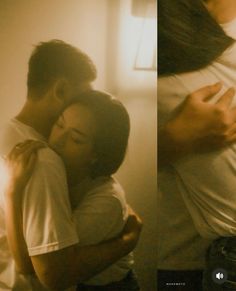 two people are hugging each other in the same room and one person is wearing a white t - shirt