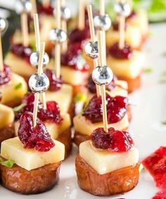 small appetizers are arranged on a plate with toothpicks in the middle