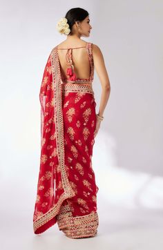 Embrace elegance with this delicate floral jaal sari, featuring layered frills, flounce, and an intricately embroidered border. The easy wrap design is complemented by a classic sleeveless printed blouse that adds a touch of glamour and glitz, making this ensemble perfect for any special occasion. Sleeveless Pre-draped Saree With Intricate Embroidery, Traditional Embroidered Sleeveless Pre-draped Saree, Festive Sleeveless Embroidered Pre-draped Saree, Festive Sleeveless Saree With Intricate Embroidery, Festive Pre-draped Sleeveless Saree With Intricate Embroidery, Festive Sleeveless Pre-draped Saree With Intricate Embroidery, Red Traditional Pre-draped Saree For Transitional Season, Red Pre-draped Saree For Transitional Season, Transitional Red Pre-draped Georgette Saree