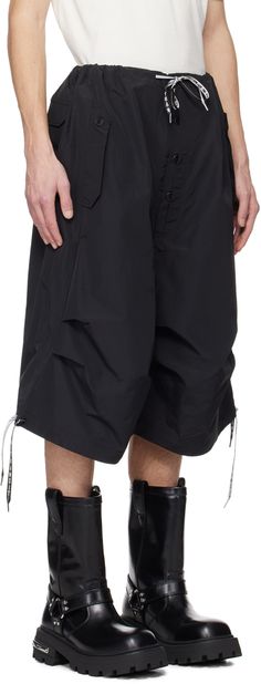 Recycled nylon- and organic cotton-blend ripstop shorts. · Drawstring at waistband and cuffs · Three-pocket styling · Exposed button-fly · Pleats at knees · Corozo hardware Supplier color: Black Summer Nylon Parachute Pants With Functional Drawstring, Summer Nylon Parachute Pants With Drawstring, Spring Nylon Shorts With Side Pockets, Summer Techwear Shorts With Functional Pockets, Summer Nylon Bottoms With Functional Pockets, Spring Nylon Bottoms With Functional Pockets, Nylon Bottoms With Functional Pockets, Spring Techwear Nylon Bottoms, Summer Nylon Shorts With Multiple Pockets